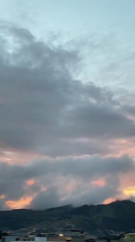 Twilight sky with crescent moon observed over Quito mountains