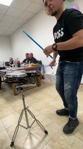 Young drummer performs with cigarette in Shkorpilovtsi room
