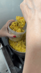 Moscow resident transfers homemade pilaf into storage container