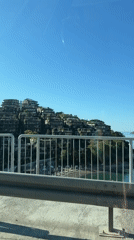 Vehicle crosses bridge in sunny Budva, Montenegro morning