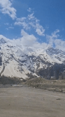 Snow-capped mountains filmed under blue skies in Tajikistan