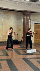 Two violinists perform in Moscow subway station