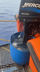 Outboard motor tested in barrel on boat deck