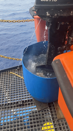 Outboard motor tested in barrel on boat deck