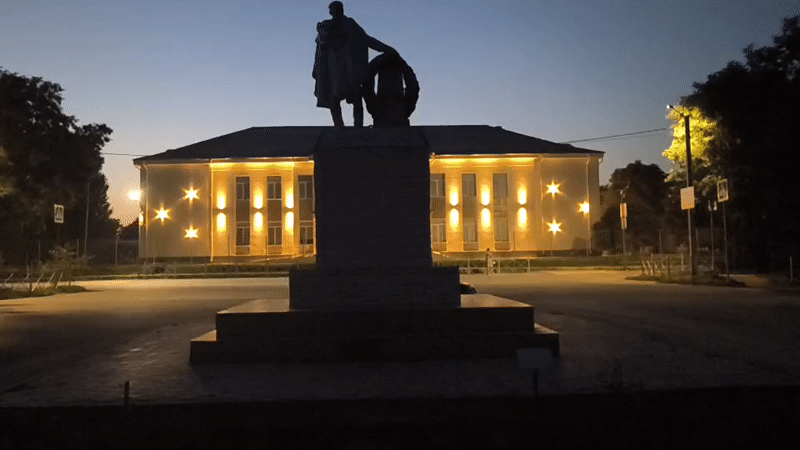 Nighttime stroll past a monument in Mikhaylovka, Russia