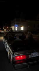 Convertibles rolling through Provincetown on a July 4th night