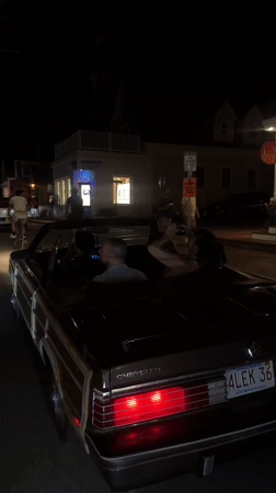 Convertibles rolling through Provincetown on a July 4th night