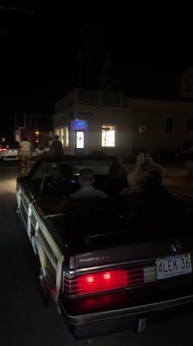 Convertibles rolling through Provincetown on a July 4th night