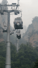 Cable cars navigate foggy night conditions in Wulingyuan mountains