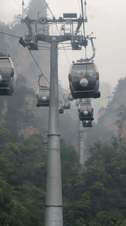 Cable cars navigate foggy night conditions in Wulingyuan mountains