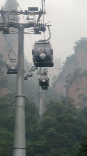 Cable cars navigate foggy night conditions in Wulingyuan mountains