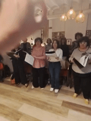 Choir performs indoors in Barcelona bookstore space