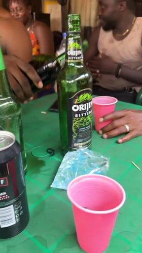 Men gather for drinks and dice games in Kurunduma