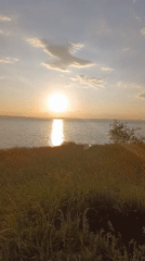 Waterside sunset gathering with camping, recreation activities documented