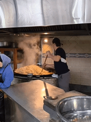 Cook prepares large batch of food in Tashkent commercial kitchen