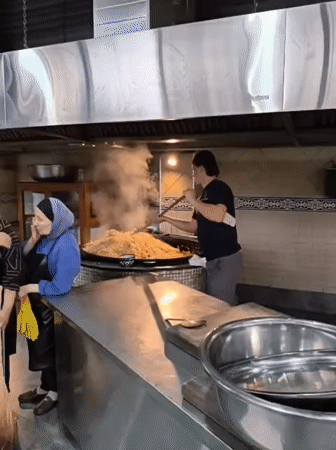 Cook prepares large batch of food in Tashkent commercial kitchen