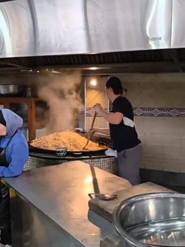 Cook prepares large batch of food in Tashkent commercial kitchen