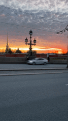 Evening street life unfolds across Saint Petersburg during sunset