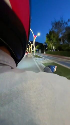 Motorcyclist rides decorated road in Fethiye at dusk