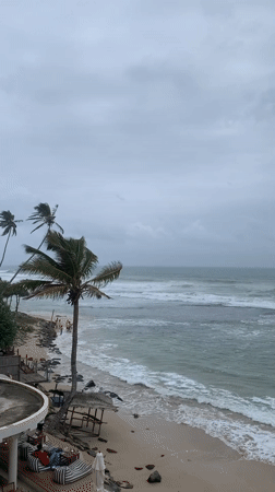 Stormy Ahangama beach morning alongside a local glassware shop
