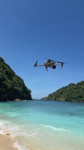Drone spotted over pristine Nusa Penida beach at dawn