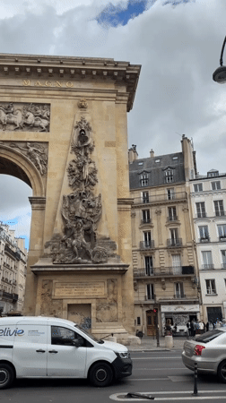 Ornate Parisian archway with Elivie van parked outside