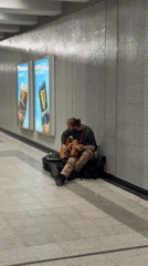 Man sits in Montreal underground passageway early morning