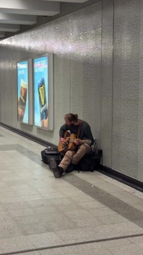 Man sits in Montreal underground passageway early morning