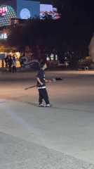 Boy practices martial arts near traditional gate in Jinzhou