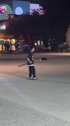 Boy practices martial arts near traditional gate in Jinzhou