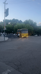 Yellow bus makes passenger stop in Yeghegnadzor, Armenia