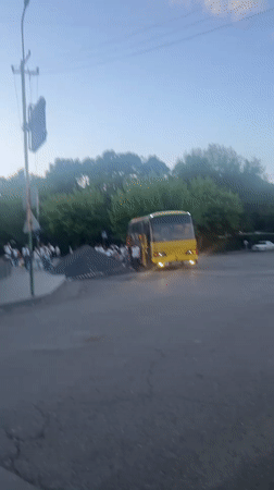 Yellow bus makes passenger stop in Yeghegnadzor, Armenia