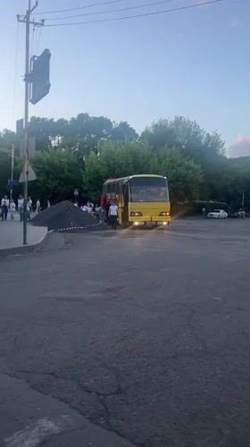 Yellow bus makes passenger stop in Yeghegnadzor, Armenia