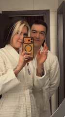 Couple takes playful bathroom selfies in white robes, Serbia