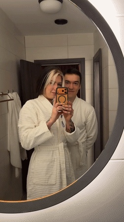 Couple takes playful bathroom selfies in white robes, Serbia