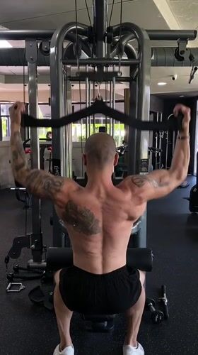 Tattooed man completes early morning workout in Pleven gym