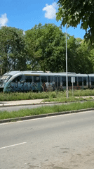 Graffiti-covered train stands still beside road in Lovech, Bulgaria