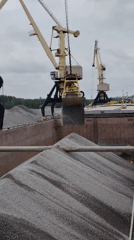 Harbor cranes load gravel at Russian port facility
