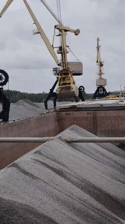 Harbor cranes load gravel at Russian port facility