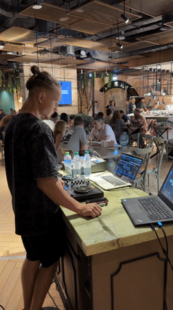 DJ performs at Dubai restaurant while patrons relax nearby