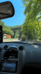Driver approaches stone arch bridge in Zmeyovo, Bulgaria