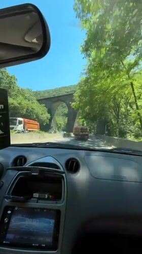 Driver approaches stone arch bridge in Zmeyovo, Bulgaria
