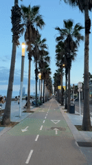 Evening beach activities captured along Barcelona promenade at sunset