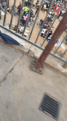 Motorcycle crowd gathers in sandy area, Kuchingoro Nigeria