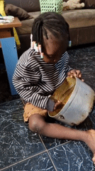 Child stirs pot on tiled floor alongside a motivational quote graphic