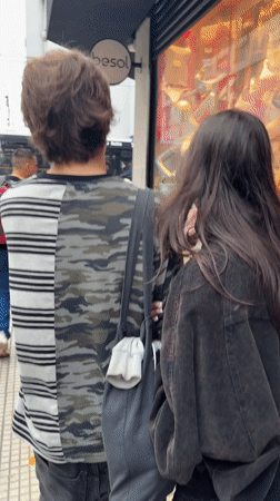 Young couple shares intimate moment on Buenos Aires sidewalk