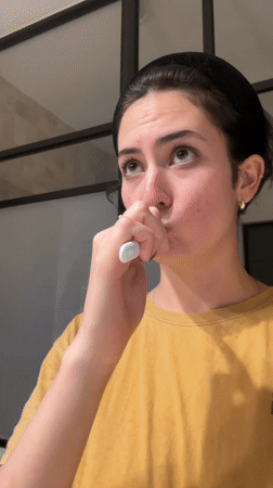 Woman brushes teeth in Puebla bathroom early morning