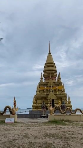 Golden Buddhist pagoda with dragon statuary observed in Thailand
