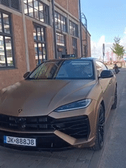 Matte gold Urus parked on Tallinn cobblestones draws a passing glance