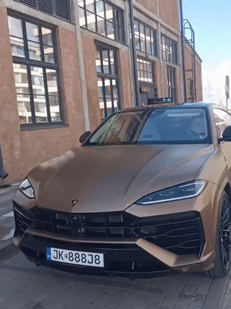 Matte gold Urus parked on Tallinn cobblestones draws a passing glance